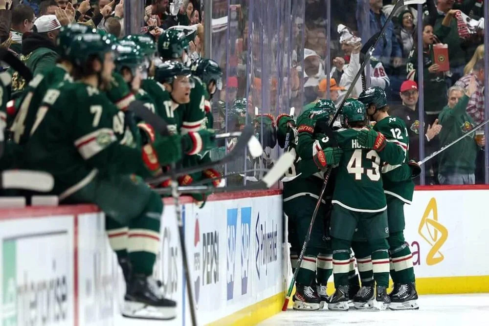 The Wild are pictured celebrating after taking a 3-0 lead on a Ryan Hartman goal in the second period on Saturday.